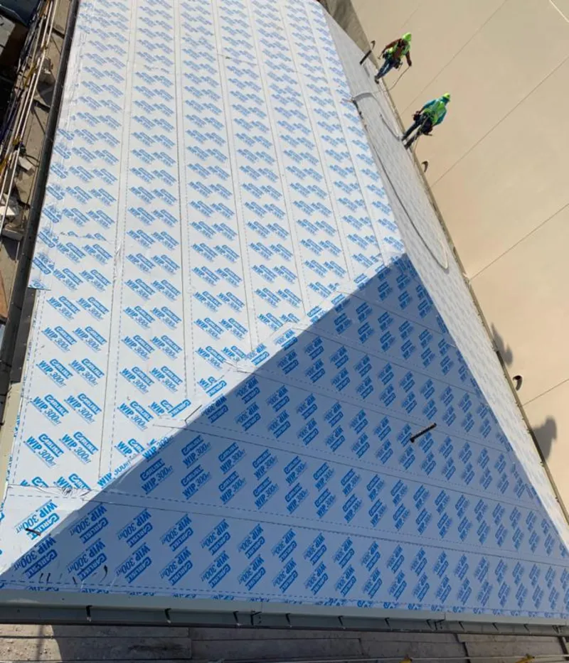 Professional roofers installing underlayment on a metal roof in Union Park